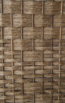 Woven wall surface features an interlocking basket-weave pattern in natural brown shades.
