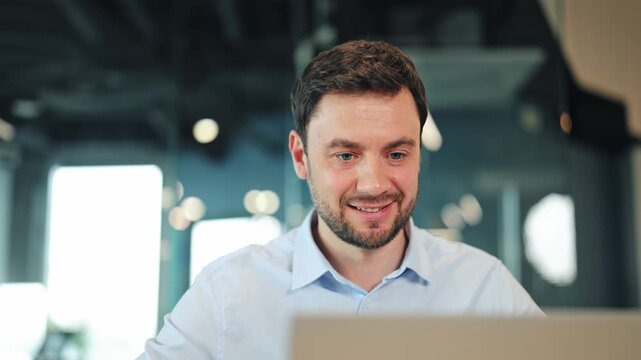 Close-up of creative specialist or programmer communicating via internet video conference on laptop computer. Digital nomad having virtual business meeting at workspace desk with blurred background.