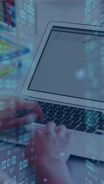 Vertical video: Woman placing hands on laptop keys, typing to fill data with blue overlay drifting