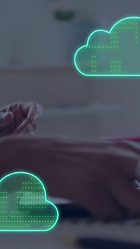 Vertical video: Woman tapping phone starting cloud sync around devices placing phone typing laptop