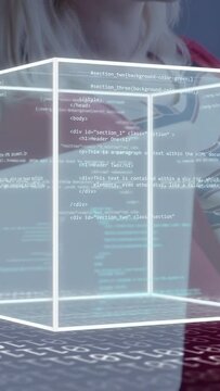 Vertical video: Techdev raising hand on grid, cube displaying code for demo while peer watching