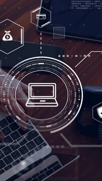 Vertical video: Woman typing on laptop hands entering left HUD overlaying payment card and bag icon
