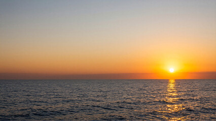 Fototapeta premium Golden Sunset Painting the Calm Ocean Horizon with Warm Hues