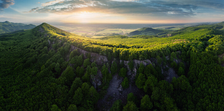 Forest nature landcape with peak and sun at dramatic sunset