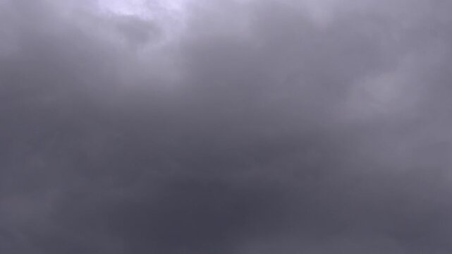 Timelapse of Dark Grey Clouds Moving and Gathering in Dramatic Overcast Sky Before Rain