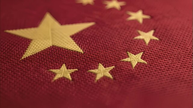 Close-up of red national flag of China, prominent yellow embroidered stars, detailed fabric texture, showcasing rich symbolism of patriotism, national identity and cultural heritage of East Asia