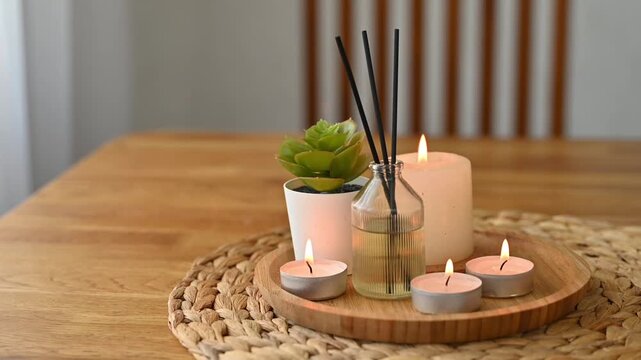 Elegant spa concept arrangement with aroma essential oil, burning candles and a diffuser symbolizing relaxation