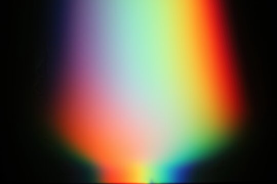 Abstract soft gradient background with vibrant complementary colors blending on a dark backdrop.