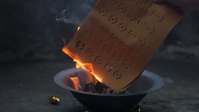 Burning Joss Paper Offering in Ritual Bowl
