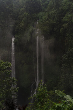 Twin waterfalls cascading through misty tropical rainforest, Bali