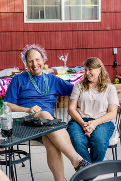 Happy adult friends laughing at outdoor party