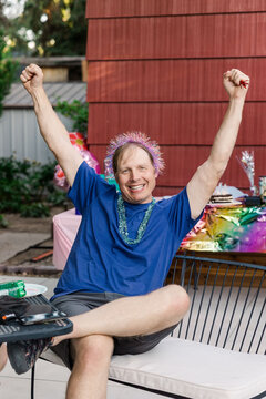 Cheerful adult man celebrating outdoors