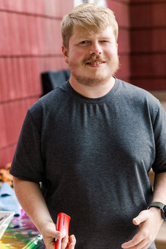 Man smiling and winking outdoors