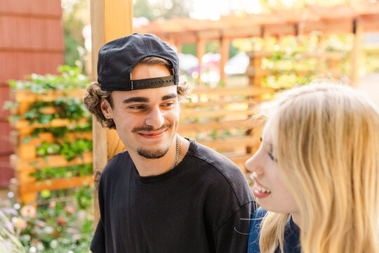Happy young friends talking outdoors