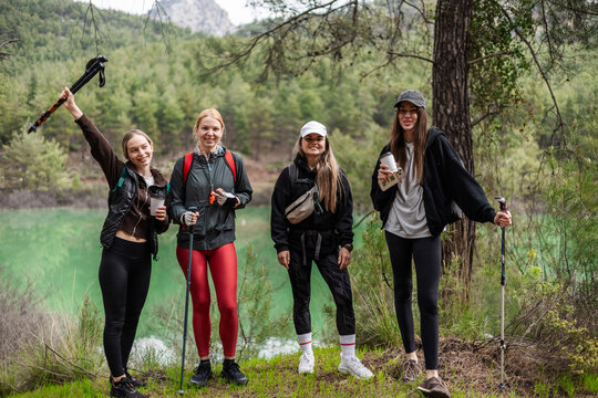 Four women friends pose for a photo on a scenic hike