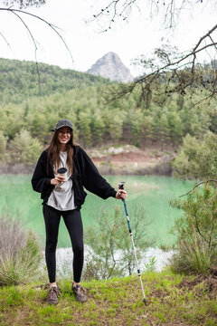 Young woman takes a coffee break during hike