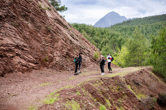 Three friends taking a break on a mountain trail