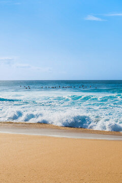 Surfing culture and community at Pipeline beach on a sunny day, Hawaii