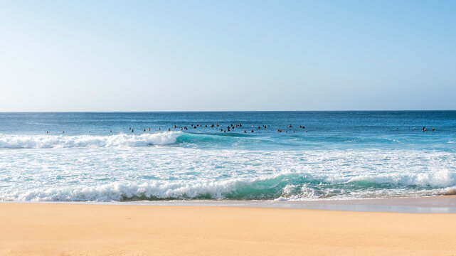 Group of surfers in the lineup at Banzai Pipeline in Oahu, Hawaii