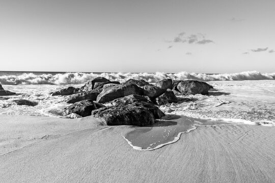 Powerful ocean waves crashing on rocks at Ehukai Beach