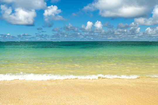 Scenic ocean horizon with soft waves on a tropical beach in Hawaii