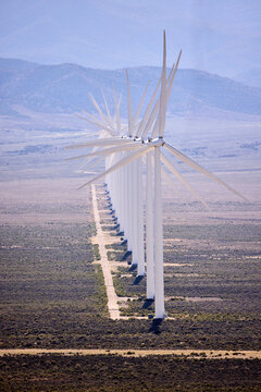 A long row of wind turbines in the desert