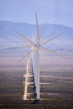 Line of giant wind turbines in the high desert