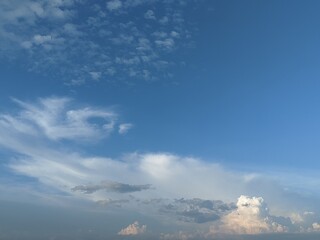 Naklejka premium Panoramic view of vibrant blue sky filled with fluffy white cumulus clouds and wispy cirrus patterns. Nature background perfect for backgrounds, wallpaper, presentation backdrop, graphic design.