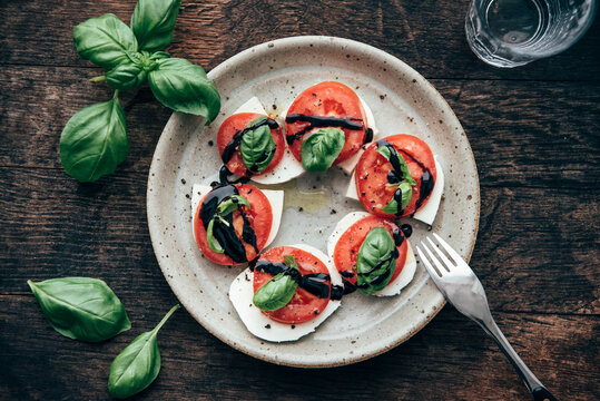 Caprese salad with San Marzano tomato and Buffalo Mozzarella and basil leaves