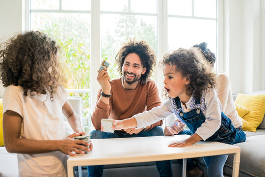 Family sitting on couch , playing memory game