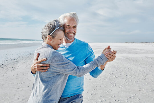 Happy couple dancing on the beach