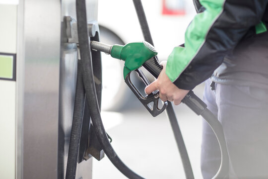 Petrol attendant holding petrol pump