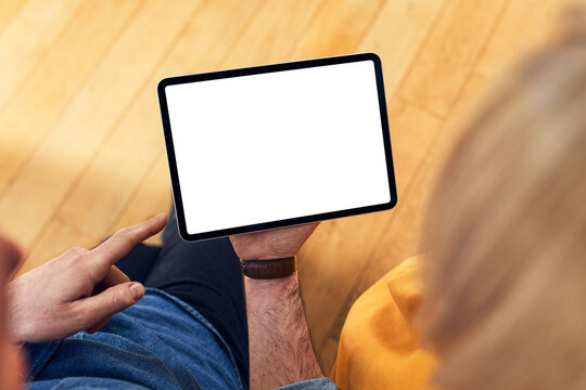 Couple using tablet with blank screen at home