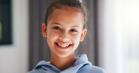 Naklejka premium Home, portrait and smile of girl child in morning for development, future or growth. Happy, space and teeth with adolescent kid in living room of apartment for holiday, optimism or weekend break