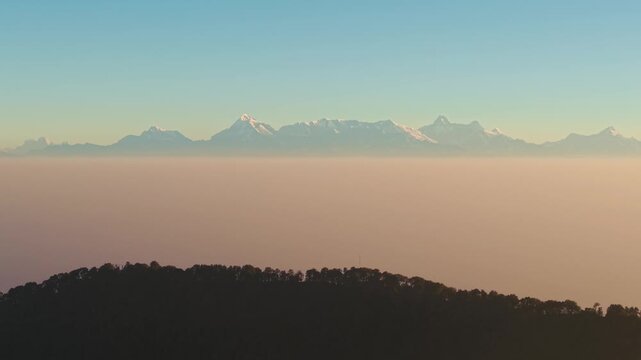 4K scenic aerial shot of the majestic Himalayan mountain range during sunrise in Uttarakhand, India.