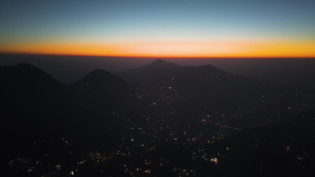 4K cinematic drone footage of Nainital city lights at sunrise with vibrant morning skies and Himalayas in Uttarakhand, India.