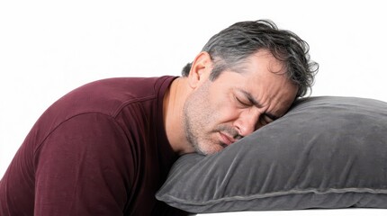 Obraz premium picture of an exhausted middle aged man resting his heavy head on a smooth grey velvet pillow with eyes closed in annoyance wearing a soft burgundy cotton shirt hands completely hidden