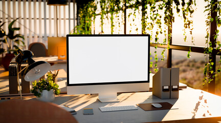 Modern Office Workspace with Computer Blank Screen and Sunlight