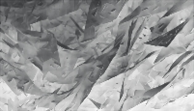 Crinkled paper texture fills the frame with sharp folds.