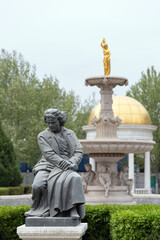 Obraz premium A Beethoven statue and European-style garden fountain in the Italian Style Town district of Tianjin, cityscape photography