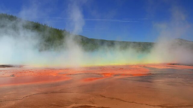 Grand Prismatic Spring vibrant colorful orange hot springs pool Midway Boardwalk trail Mid Geyser Basin Wyoming USA Yellowstone National Park nature landscape Opal Pool sunny morning blue sky pan