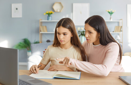 Attentive loving mother supporting sad teenage daughter in study, together at home, young parent mom helping comforting teen, encouraging school girl in education learning at home, tutor mentor