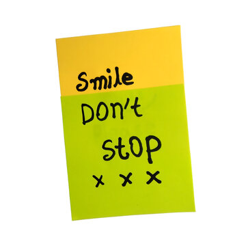 Handwritten sticky note with smiley doodle and crossed out words