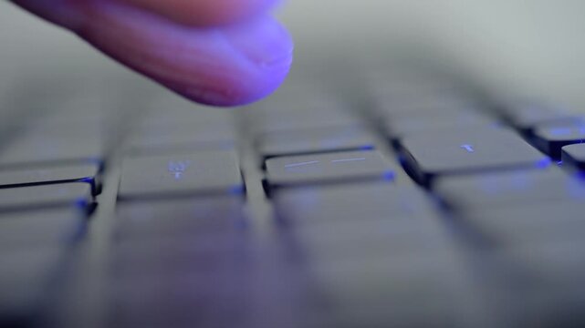 Closeup keyboard enter key release capturing relieved fingertip, student submits assignment or project, RGB highlights and shallow focus, notification ping and release of tension