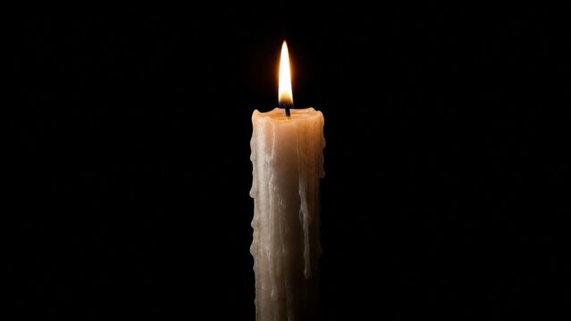  A single white candle burning with wax drips against a black background. 