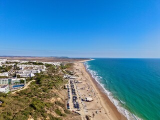 aerial view of the beautiful beach Playa de la Fontanilla and Playa De Los Bateles near the old town in Conil de la Frontera at a sunny summer day, Andalusia, Costa de la Luz, Spain © keBu.Medien