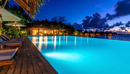 Obraz premium Luxury resort pool at dusk ocean view.