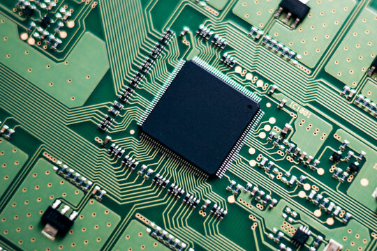 Macro close-up of a semiconductor microchip mounted on a circuit board, representing AI computing, electronics engineering, and modern digital technology
