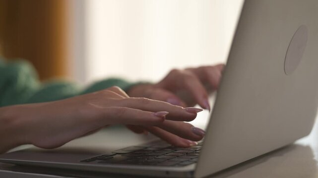 Girl with her hands typing on laptop. woman work from home concept. hands of a woman typing on a laptop. a girl with large hands lifestyle typing on a laptop.