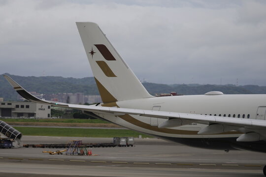 Tail fin and winglet of a Starlux Airlines Airbus A350 airplane on the taxiway.